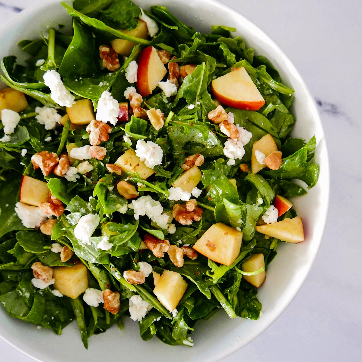 apple walnut goat cheese salad apple walnut goat cheese salad in a white bowl