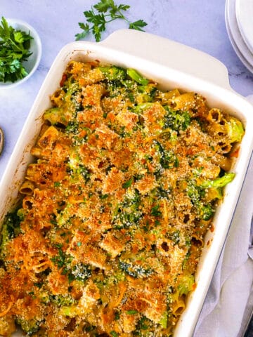 Cheesy broccoli pasta casserole in a baking dish.