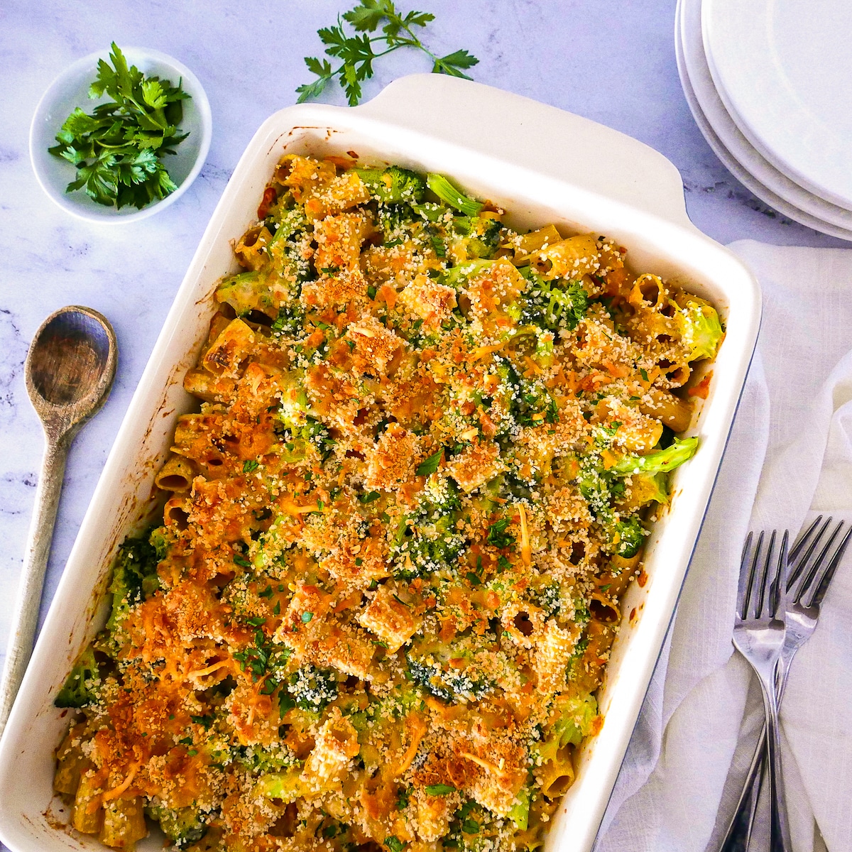 Cheesy broccoli pasta casserole in a baking dish.
