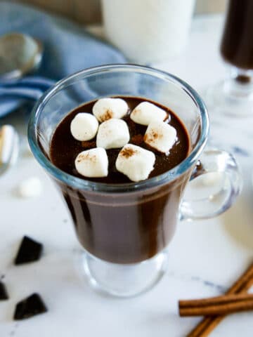glass mug of oat milk hot chocolate with marshmallows.