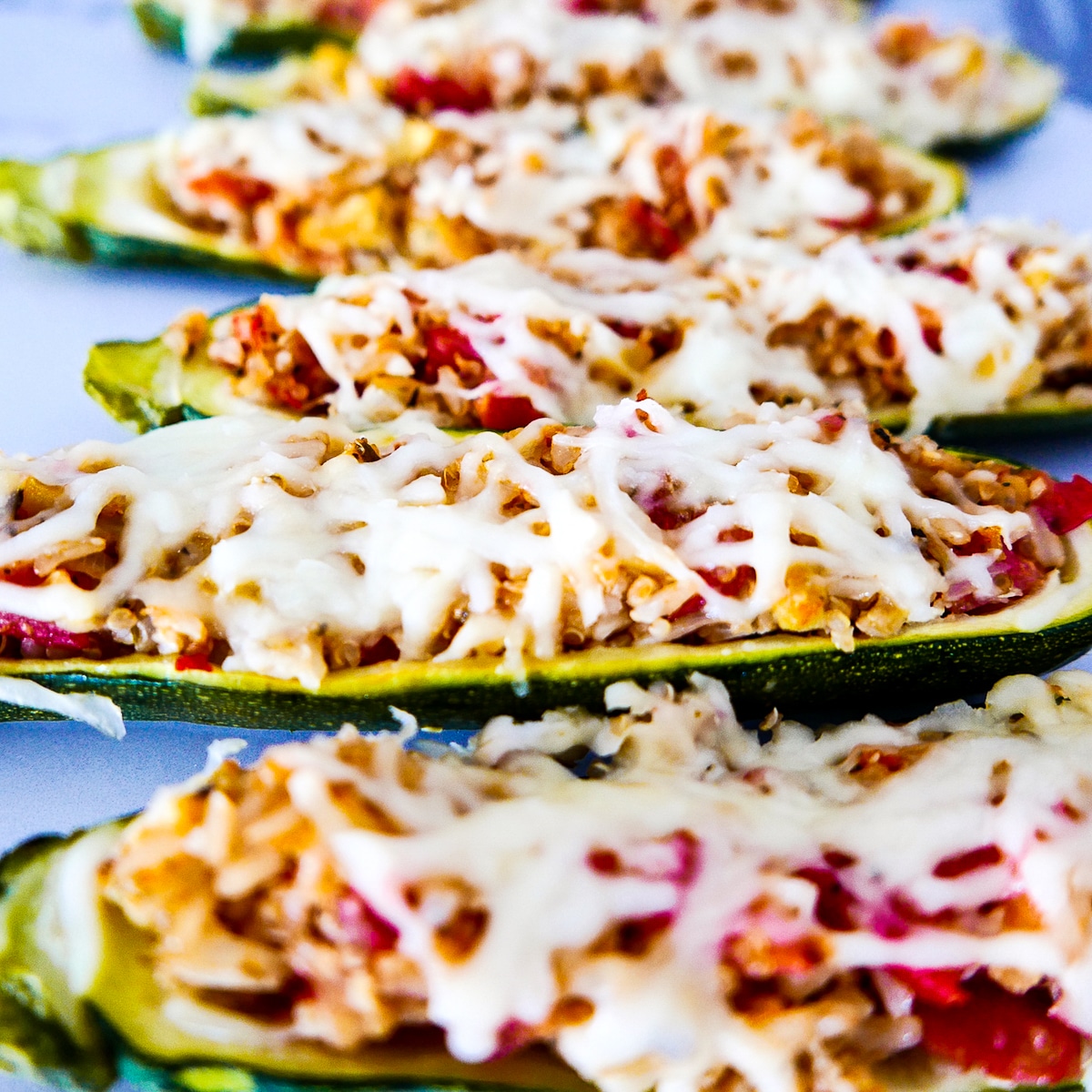 rice-stuffed-zucchini-boats.jpg rice stuffed zucchini boats topped with mozzarella