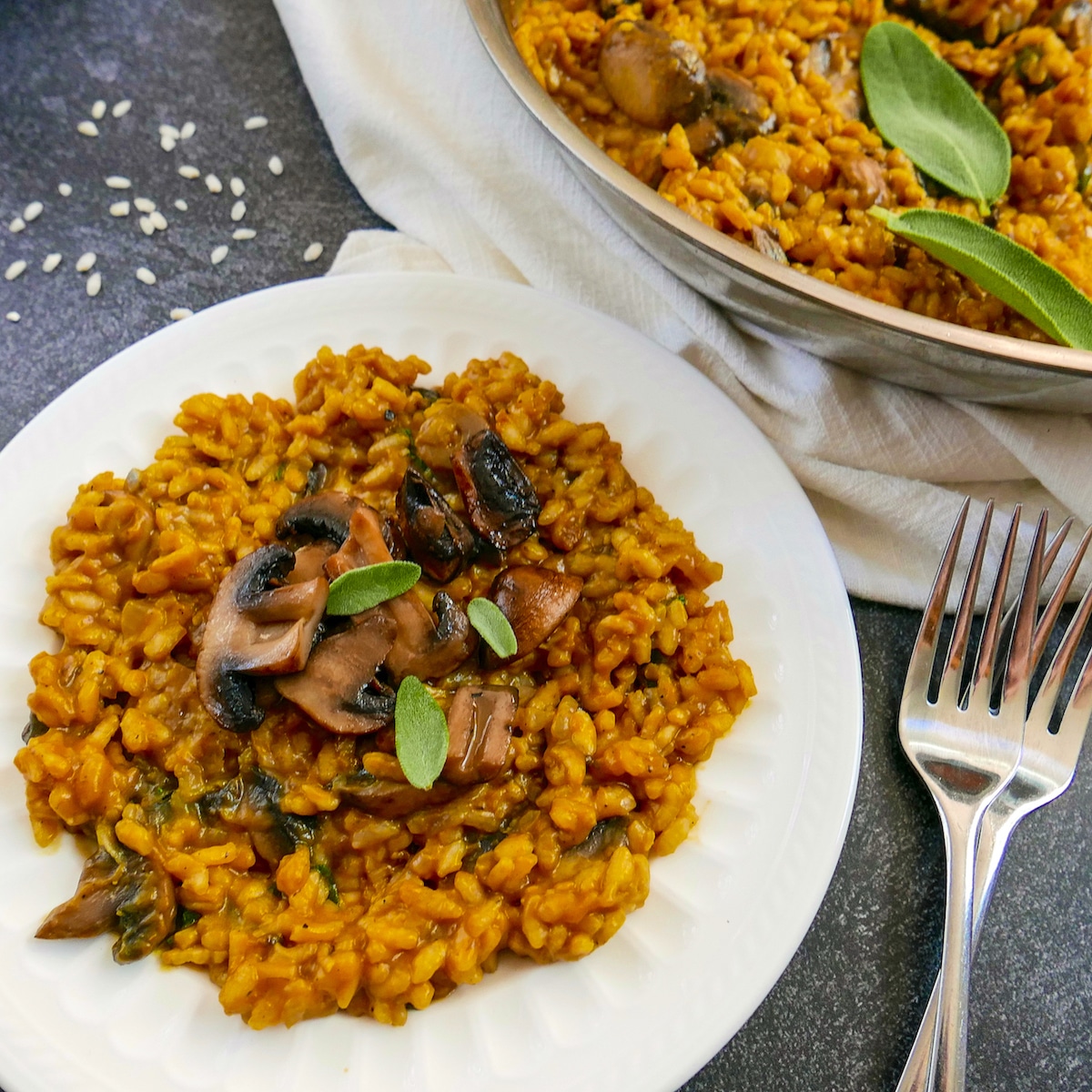 pumpkn-and-mushroom-risotto-on-a-plate.jpg Pumpkin risotto on a plate and in a pan with two forks next to them.