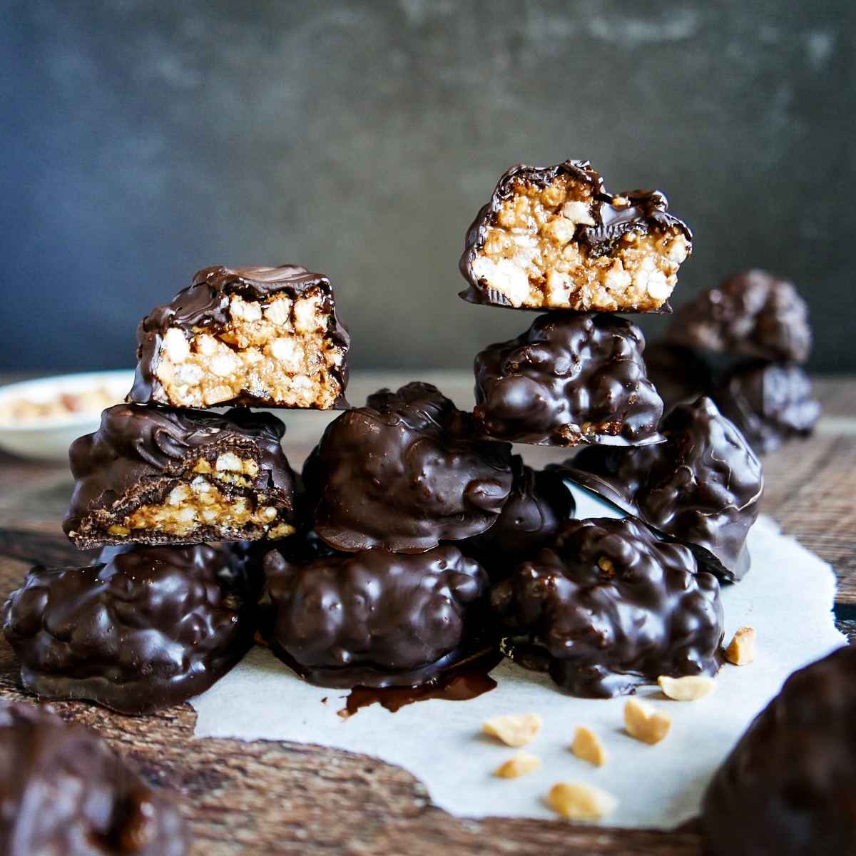 old fashioned peanut butter balls arranged in a pyramid shape with three balls cut open.
