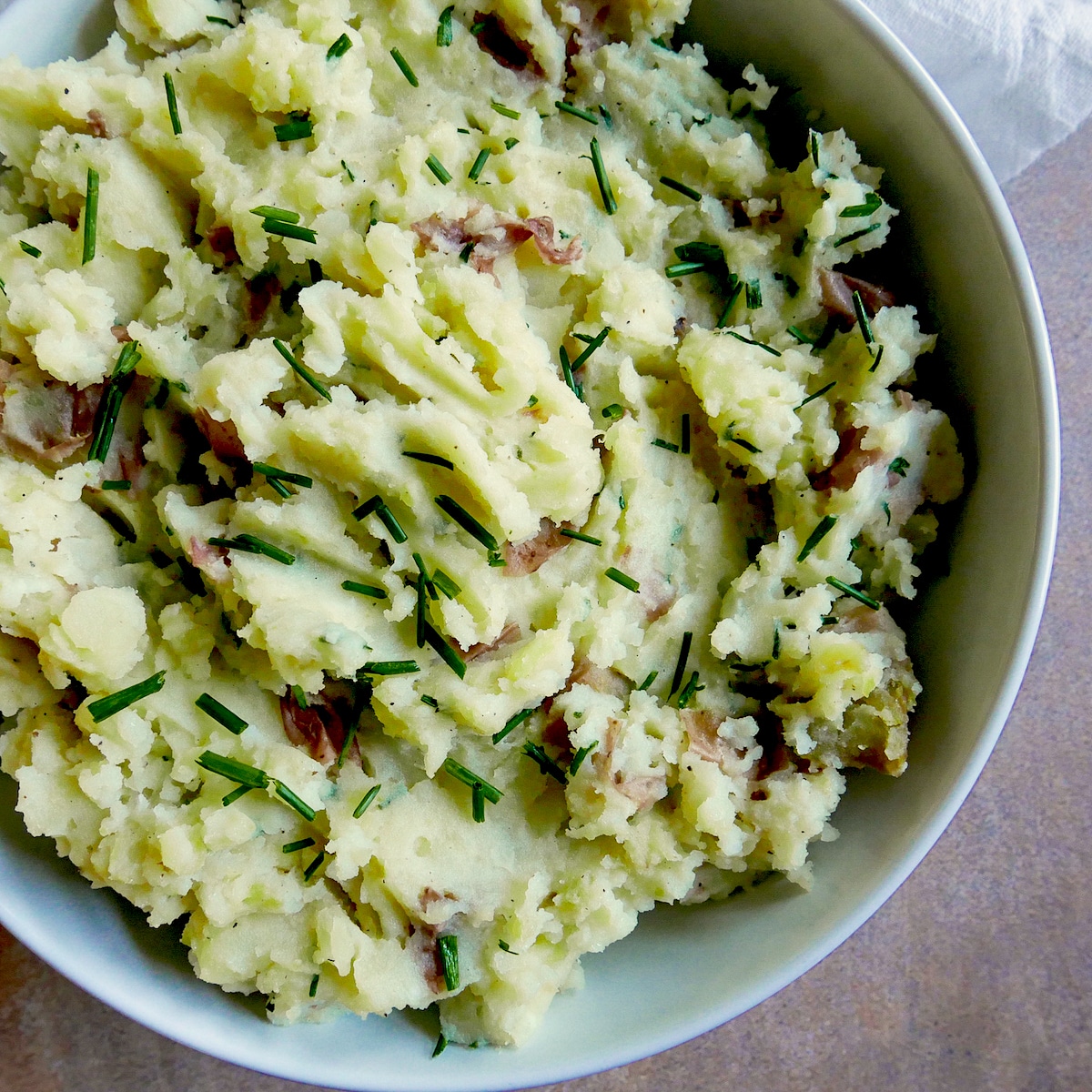 red mashed potatoes in a serving bowl.