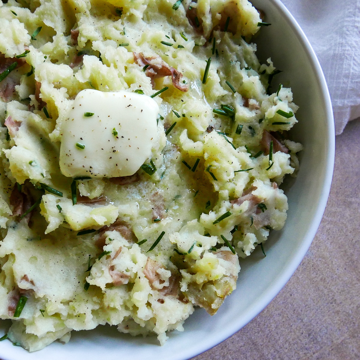 red skin mashed potatoes with butter in a large bowl.