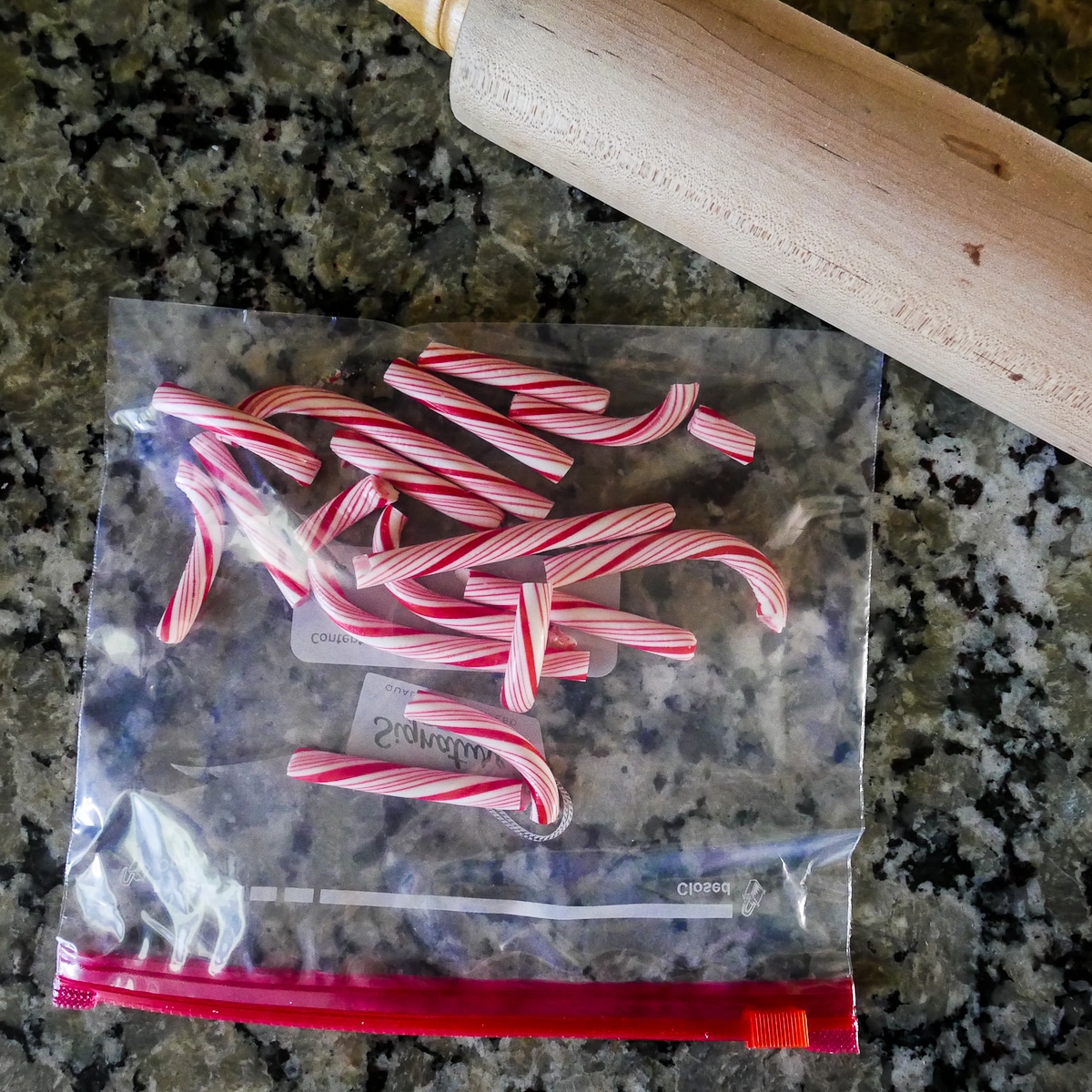 small plastic bag with candy canes and a rolling pin.