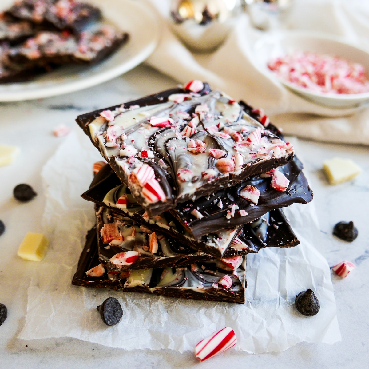 stack of vegan peppermint bark on a piece of parchment paper.