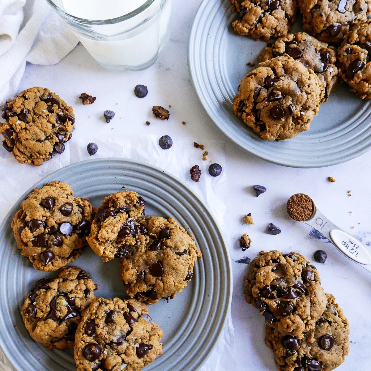 pumpkin-chocolate-chip-cookies-on-plates.jpg Dairy free pumpkin cookies arranged on two plates with a glass of milk nearby.