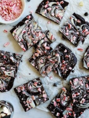 vegan peppermint bark cut into squares and arranged on parchment paper.