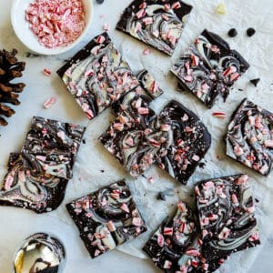 vegan peppermint bark cut into squares and arranged on parchment paper.