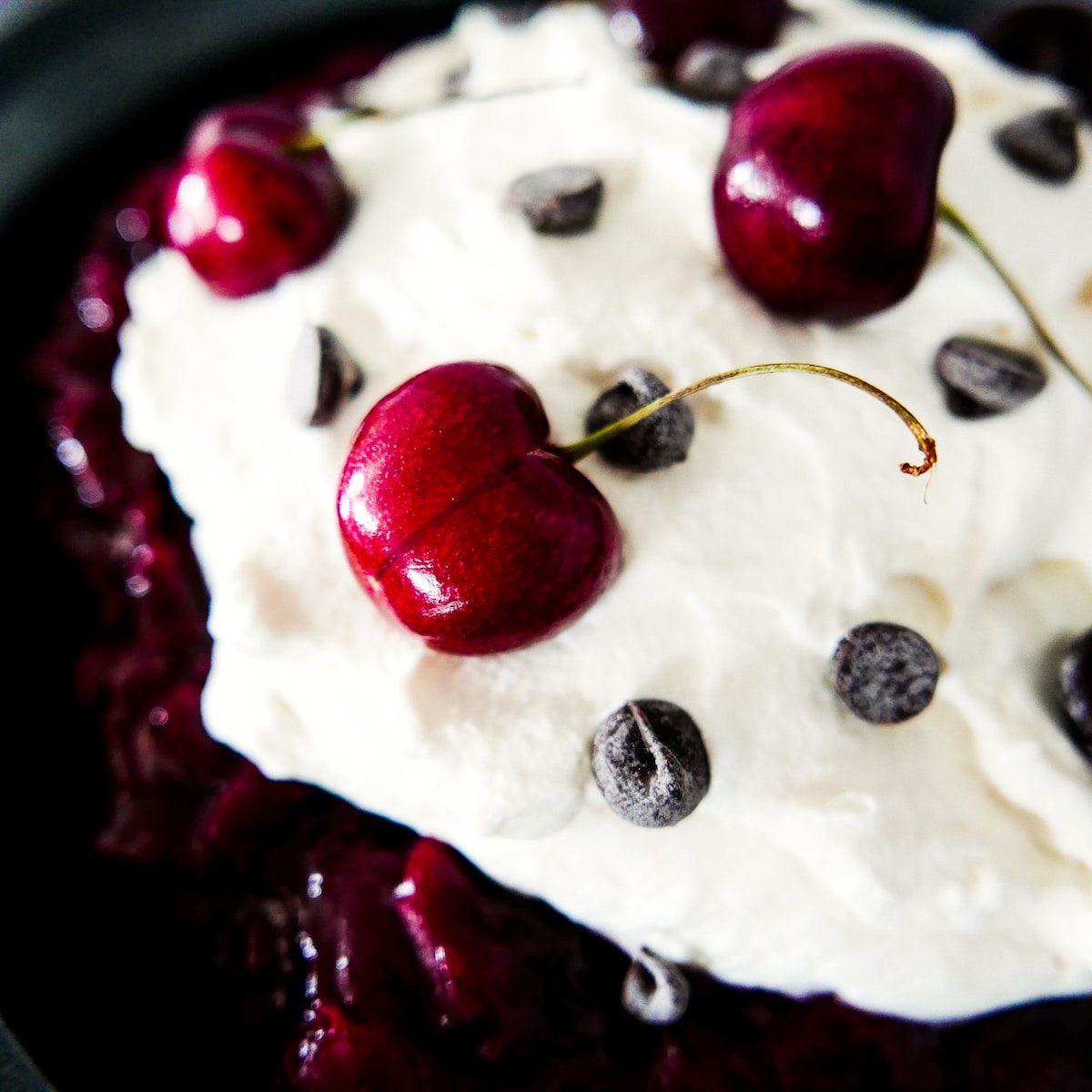 Black forest pie topped with fresh cherries and chocolate chips. 