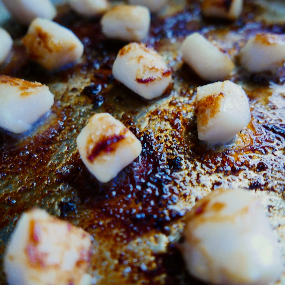 scallops sauteeing in pan.