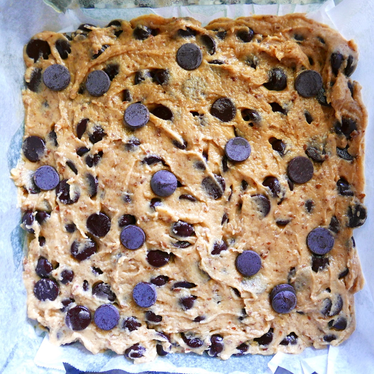 vegan-blondie-dough.jpg blondie dough spread into square baking pan.