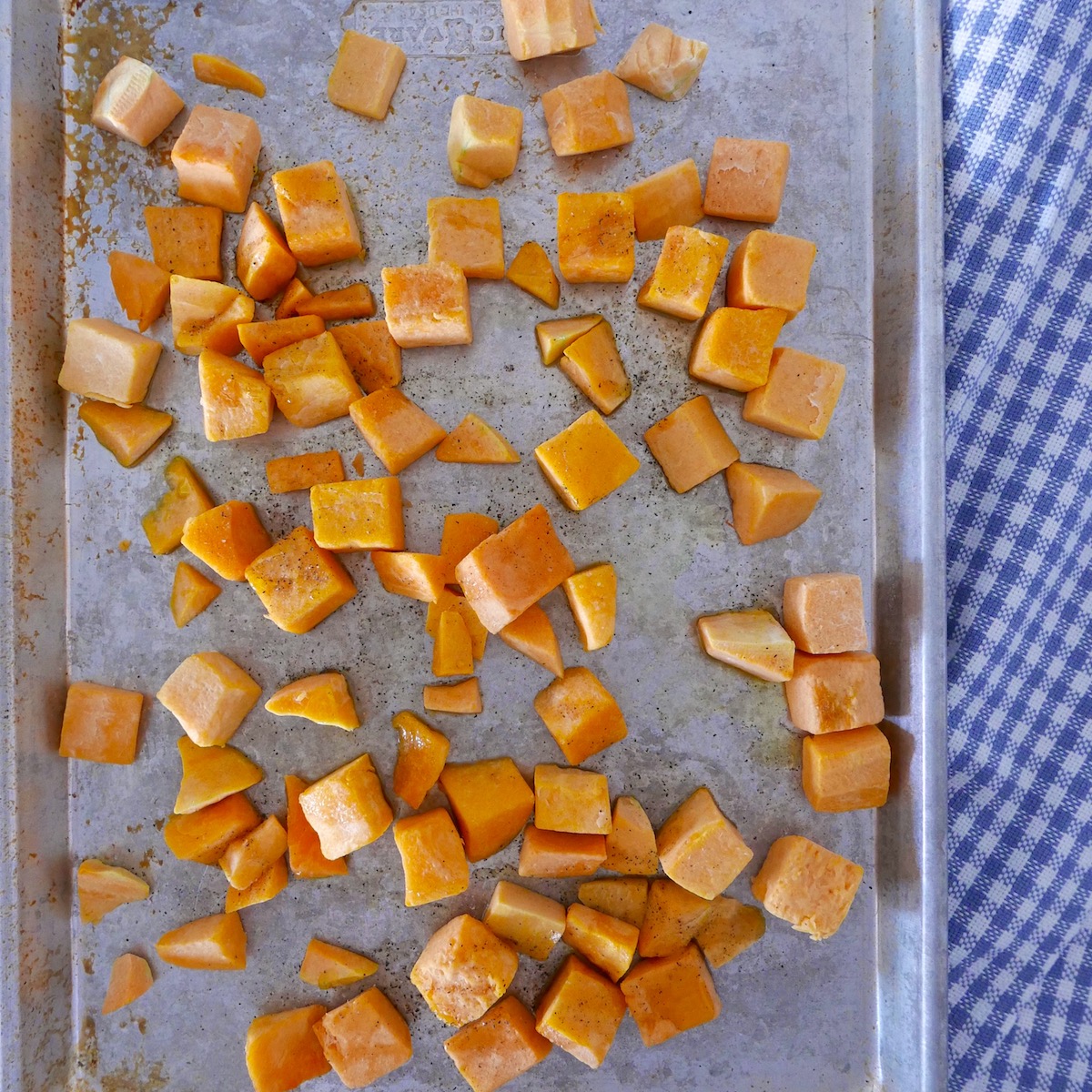 diced squash on a baking sheet.