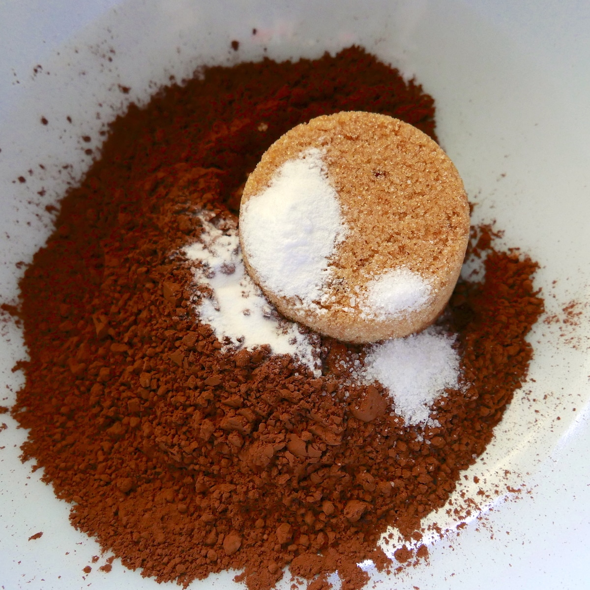 cocoa powder, sugar, baking soda, salt, and spices in a mixing bowl.