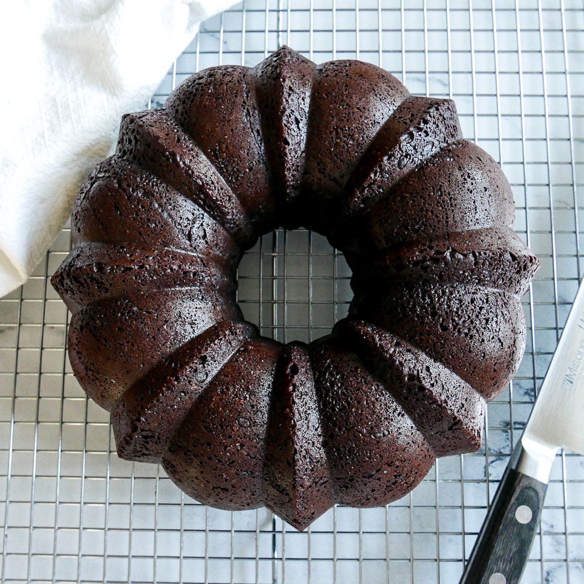 Bundt cake inverted on cooling rack.