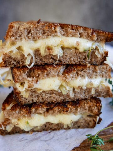 stacked grilled cheese on a cutting board