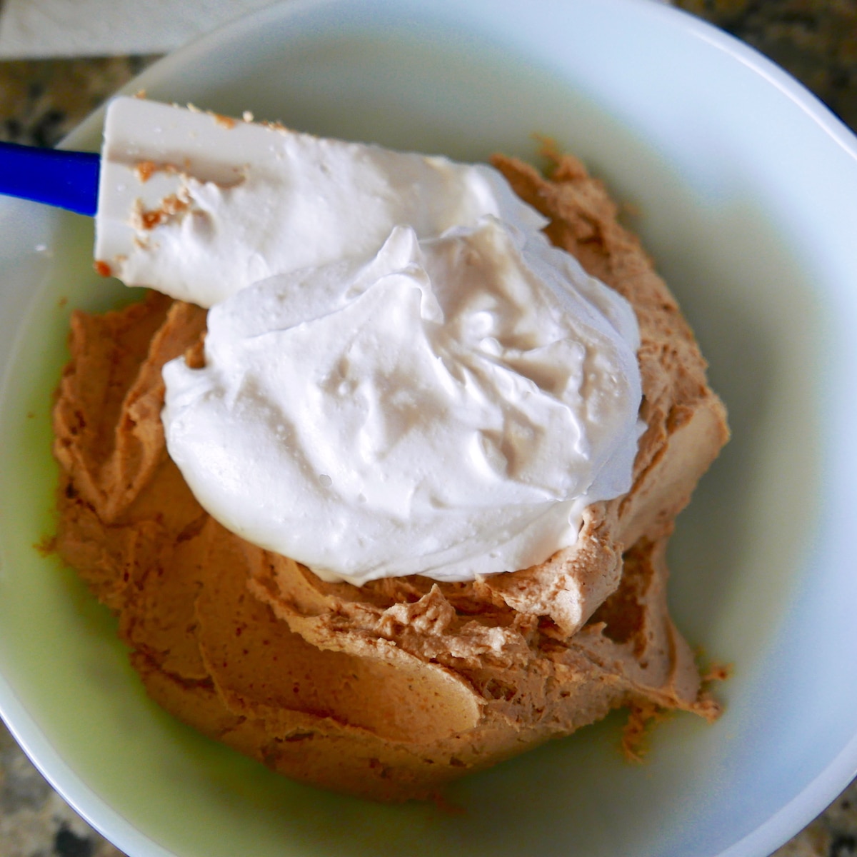 Folding coconut cream into peanut butter filling.