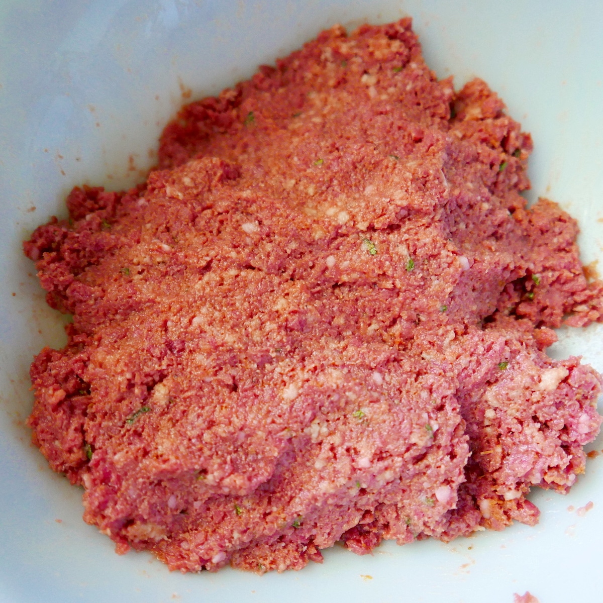 Meatball mixture in a medium bowl.