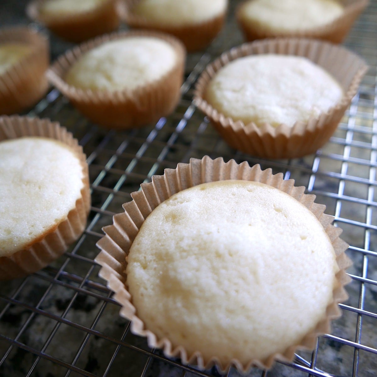 almond cupcakes on cooling rack