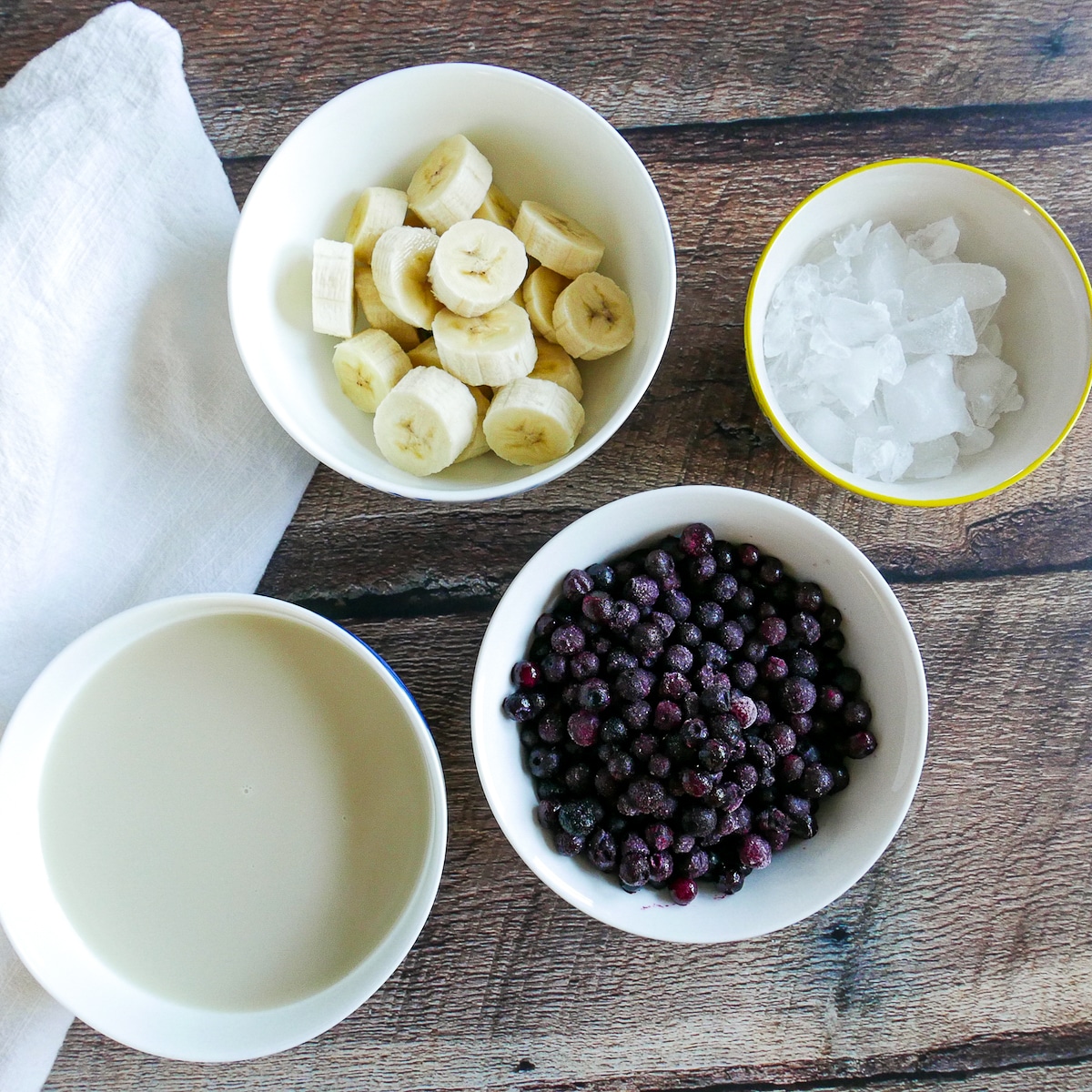 smoothie ingredients in four bowls