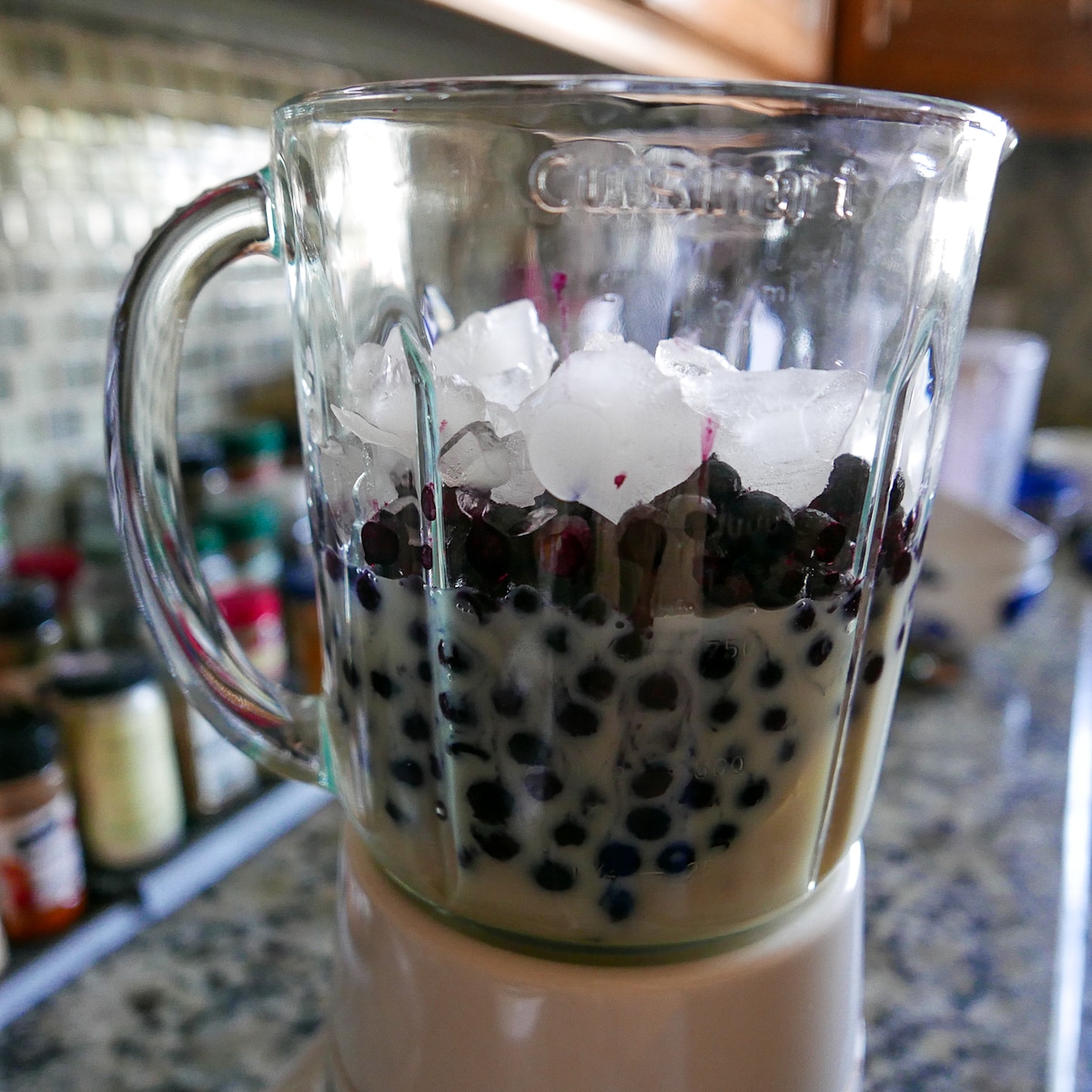 blender with smoothie ingredients inside.