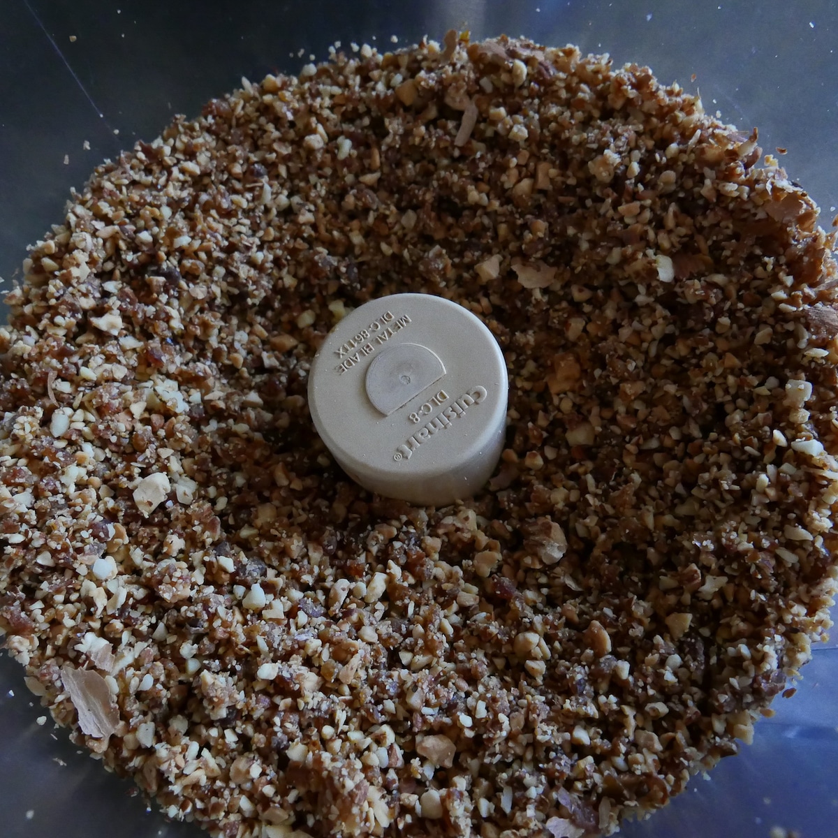 crushed almonds and dates in food processor.