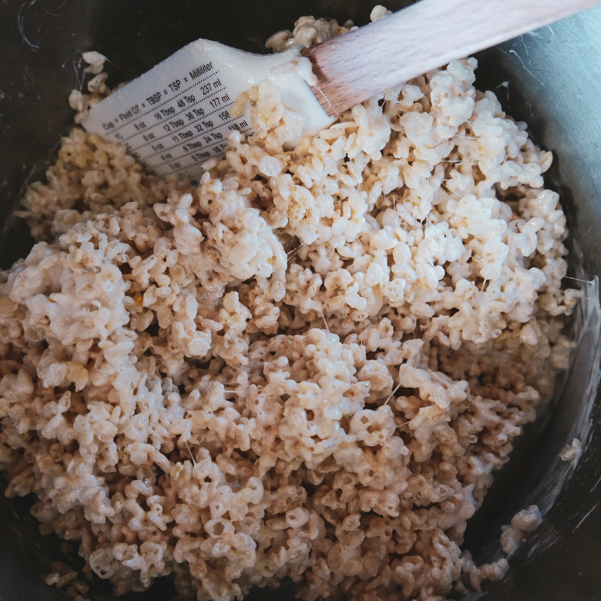 stirring rice krispies, vanilla extract, and salt into melted butter and marshmallows.