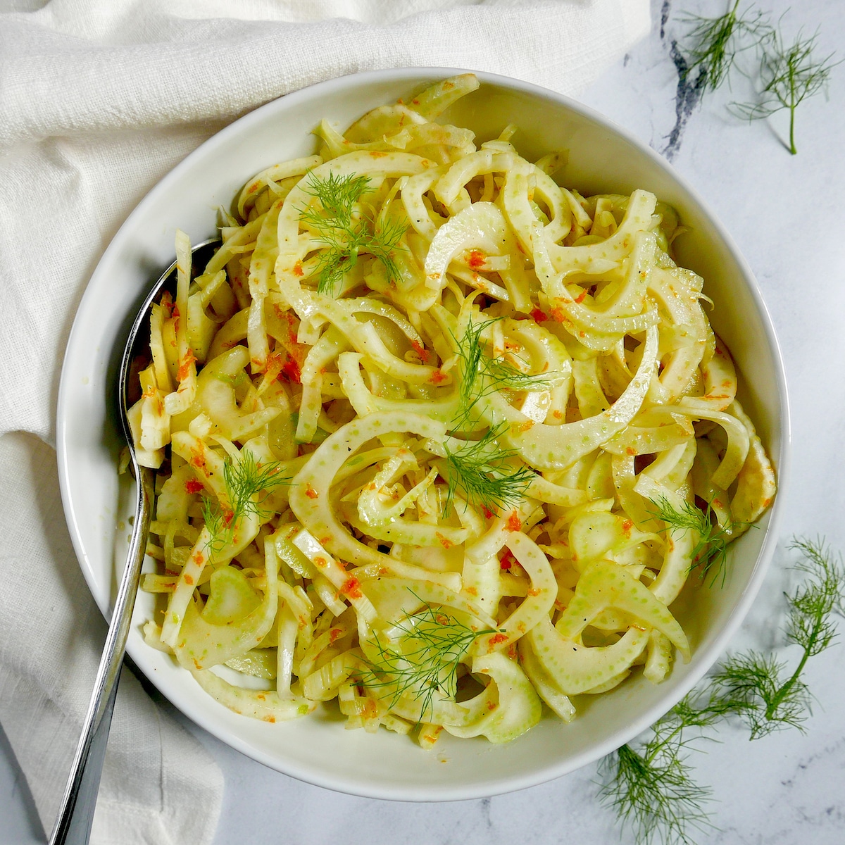 fennel salad in a bowl with spoon.