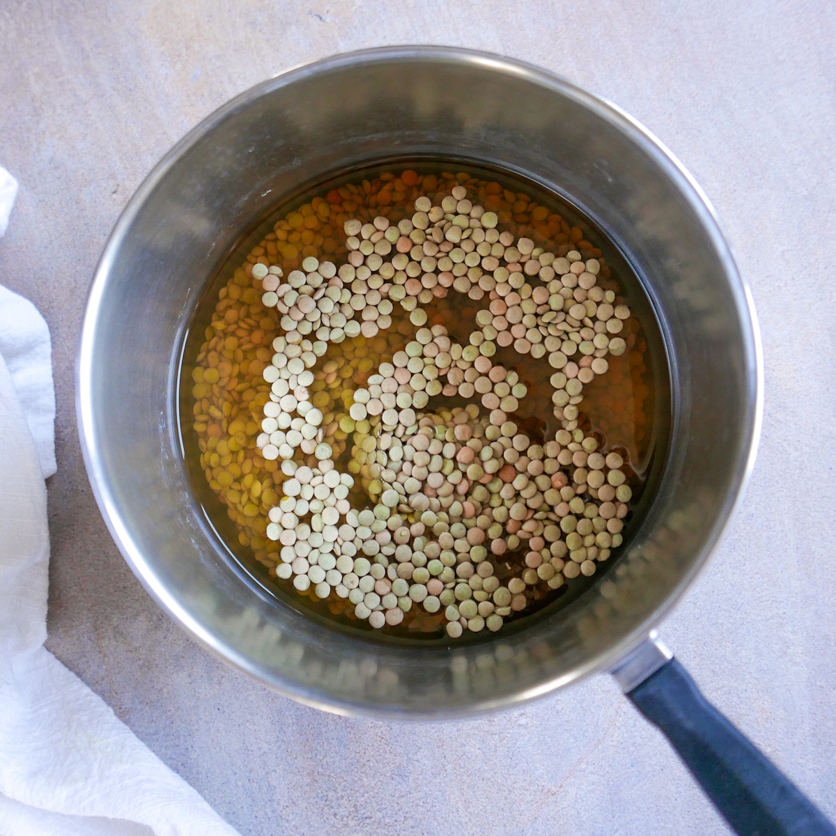 lentils and vegetable broth in a saucepan.