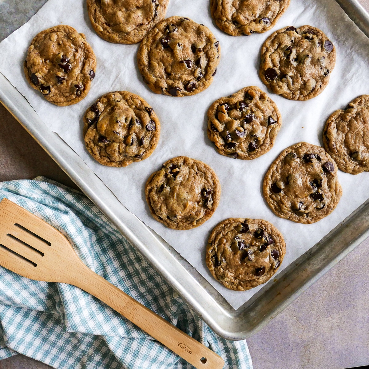 cookies baked on a baking sheet with spatula resting next to it.