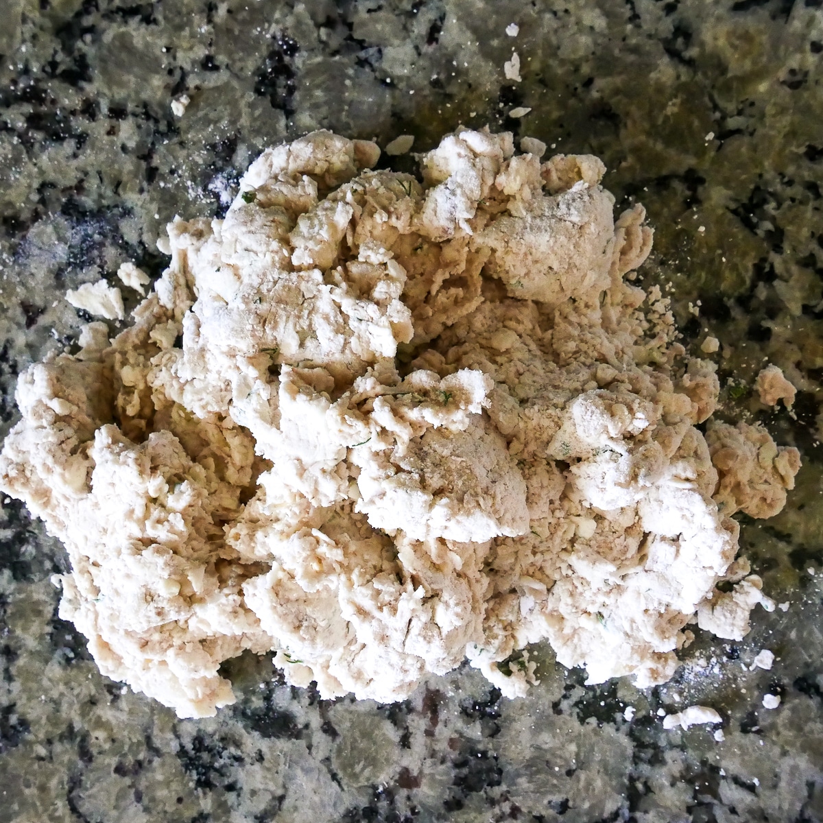 biscuit dough turned out on a counter top.