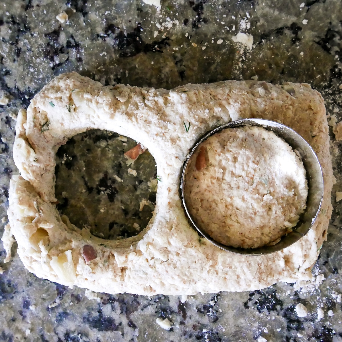 cutting out two biscuits with biscuit cutter.