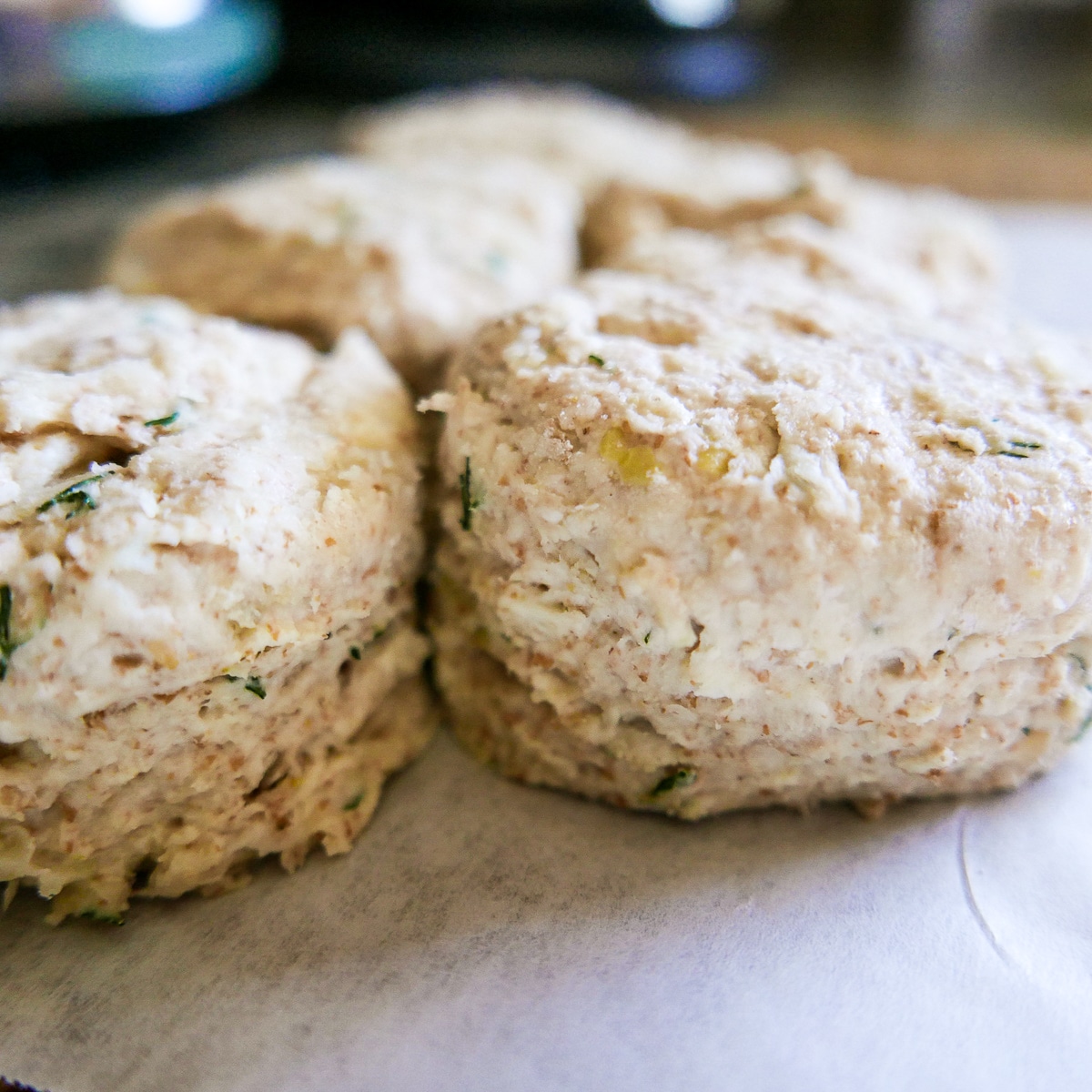 biscuits lined up on a baking sheet.