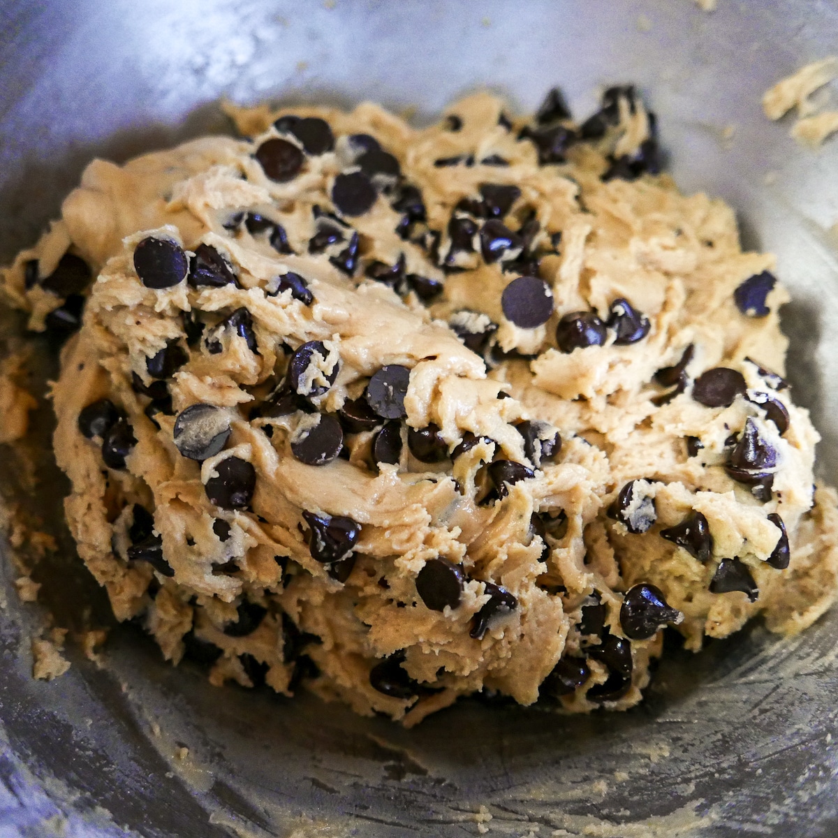 cookie-dough-in-a-bowl.jpg mixing chocolate chips into cookie dough.