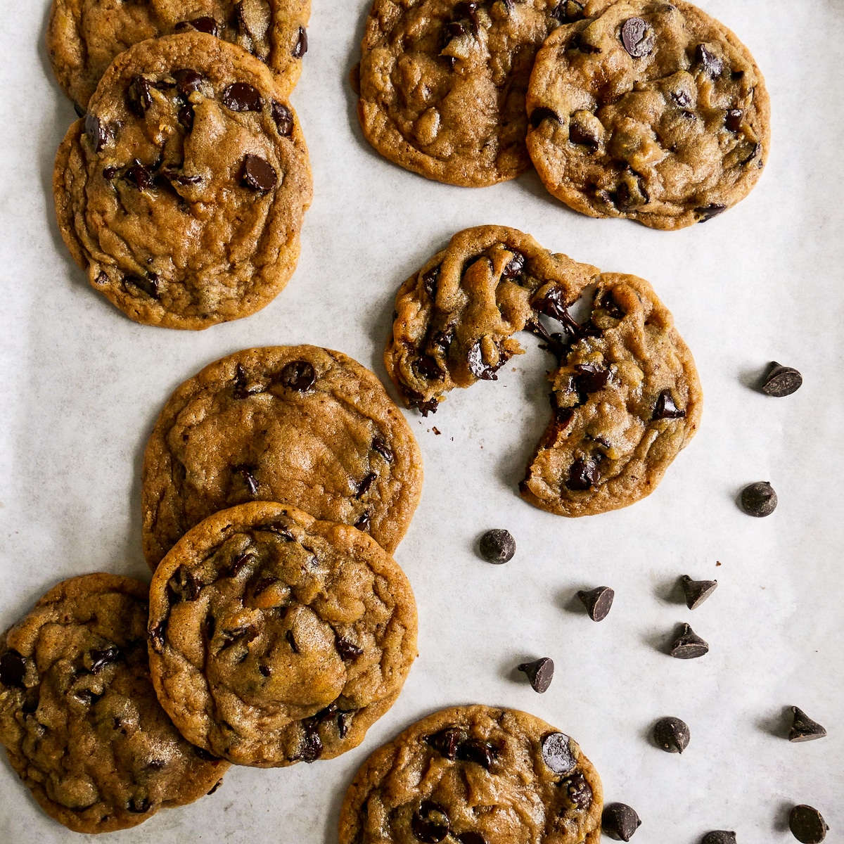 cookies arranged on a baking sheet with chocolate chips.