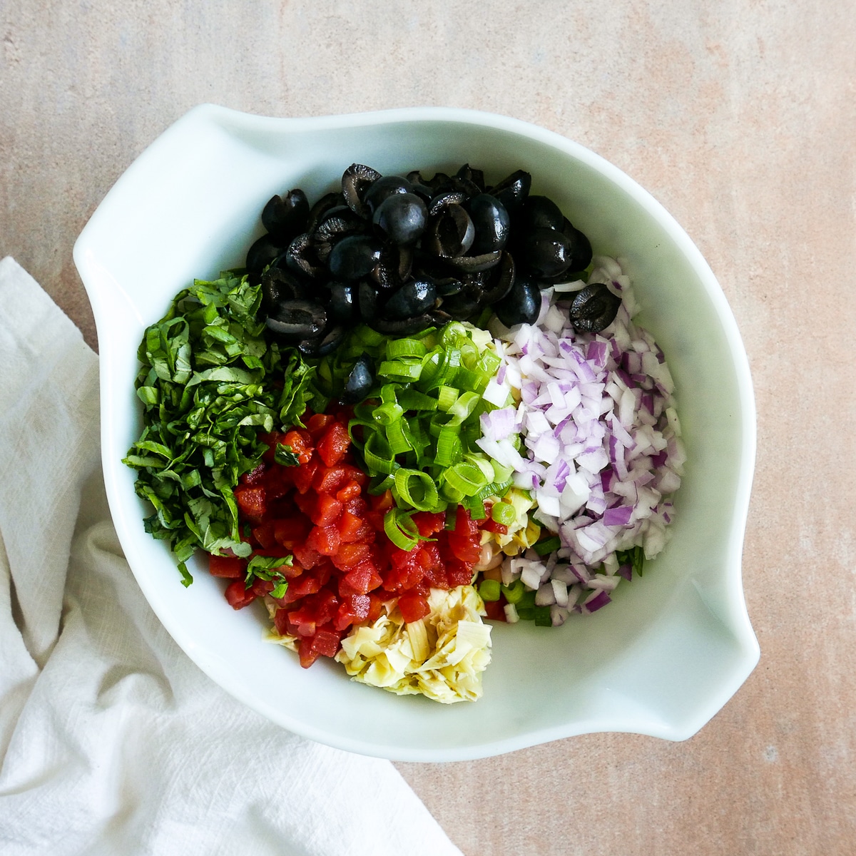 salad ingredients in a large mixing bowl.