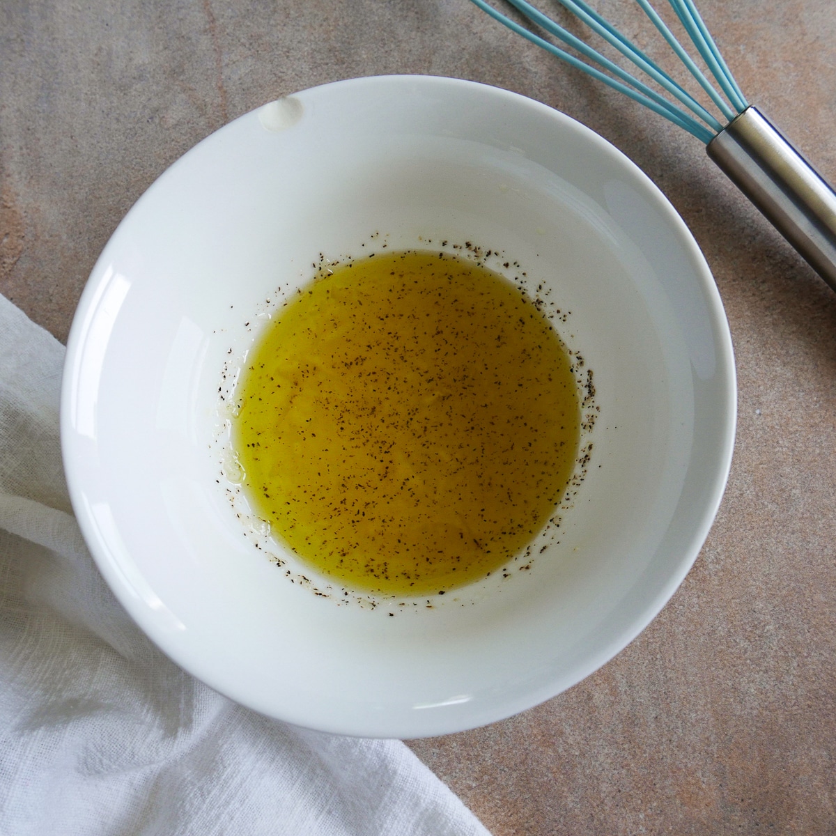 garlic vinaigrette in a small white bowl.