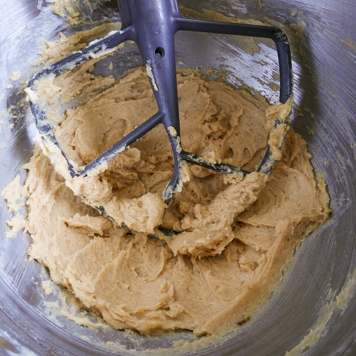 butter and sugar being creamed in a stand mixer. 