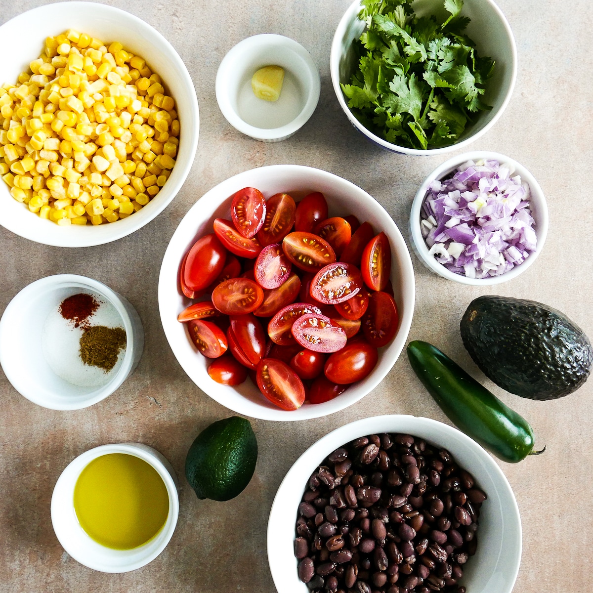 salsa ingredients arranged in bowls.