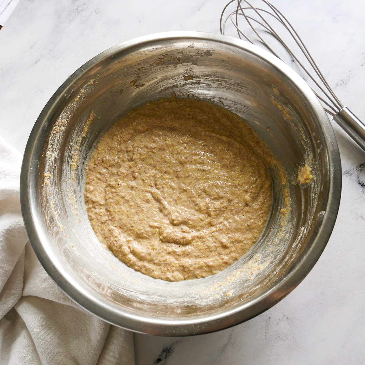 sourdough discard, milk, cornmeal, and flour mixed together in a bowl.