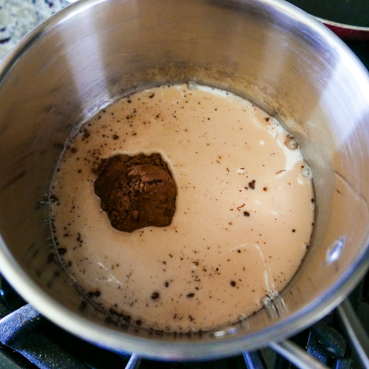 ingredients-in-saucepan.jpg maple syrup, cocoa powder, and oat milk in a saucepan.
