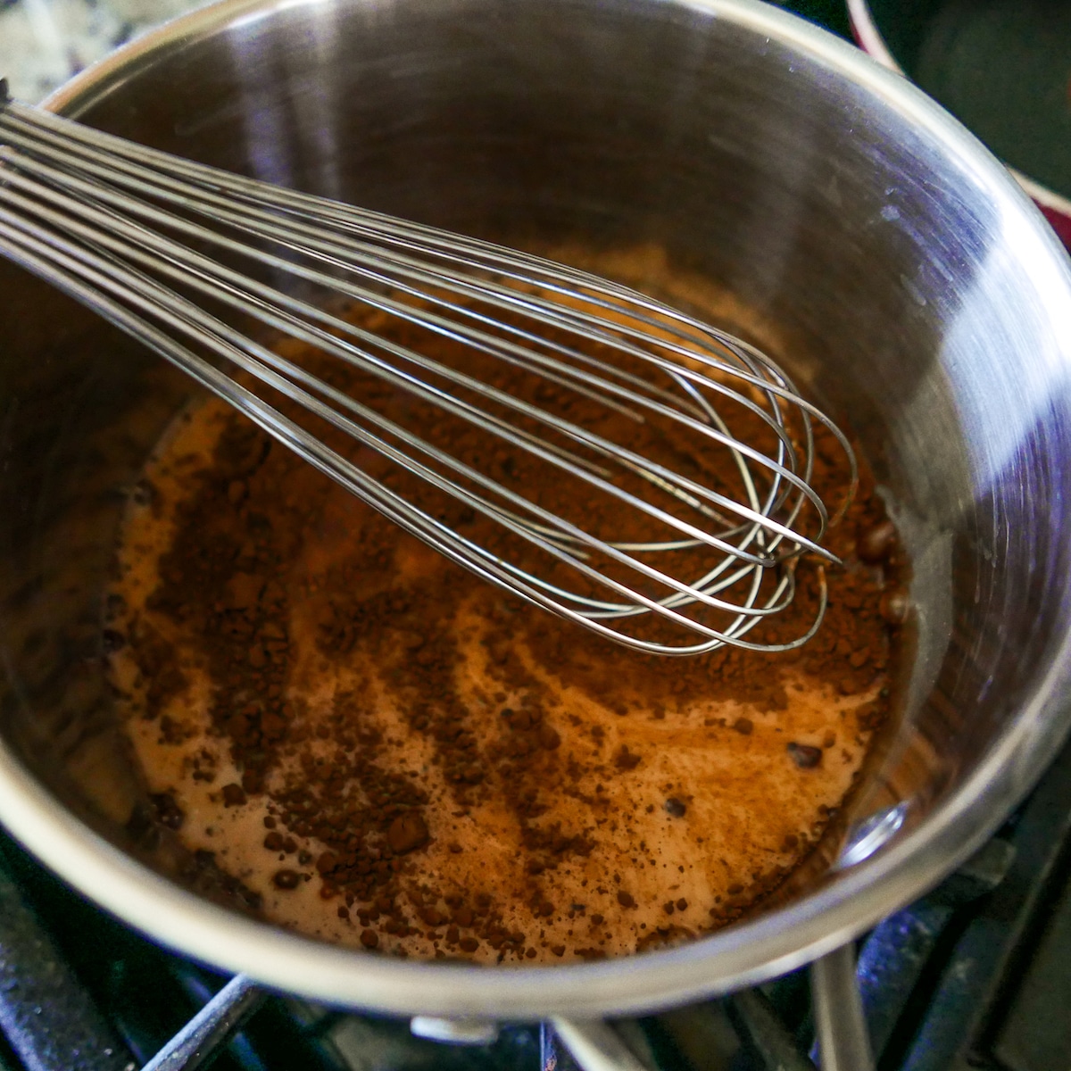 whisking-oat-milk-into-saucepan.jpg whisking in remaining oat milk and salt into saucepan.
