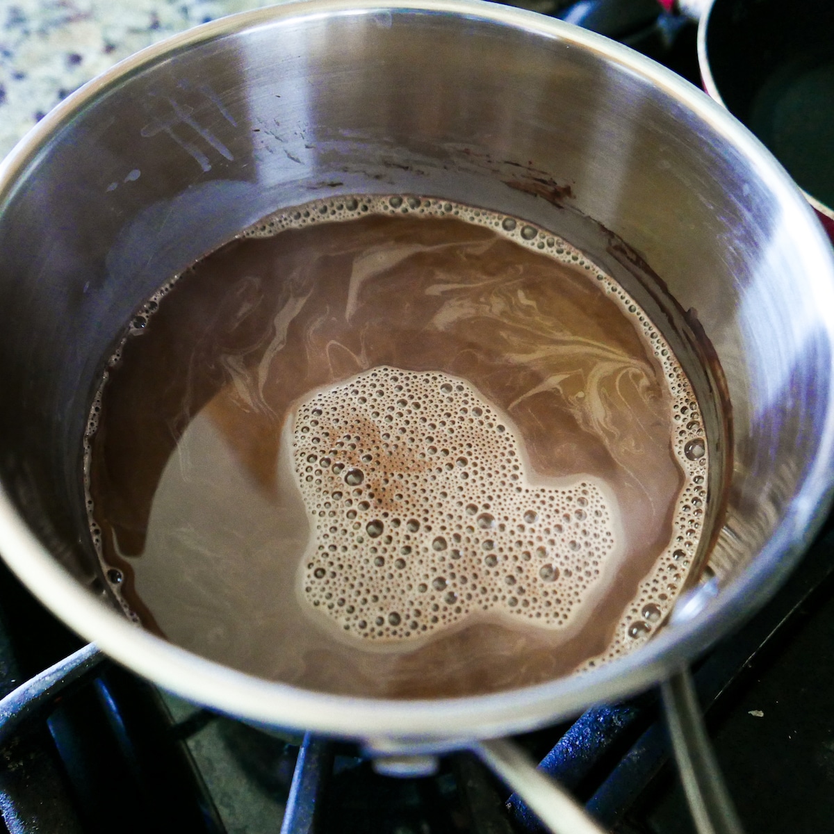 simmering-hot-chocolate.jpg Hot chocolate mixture simmering in a saucepan.