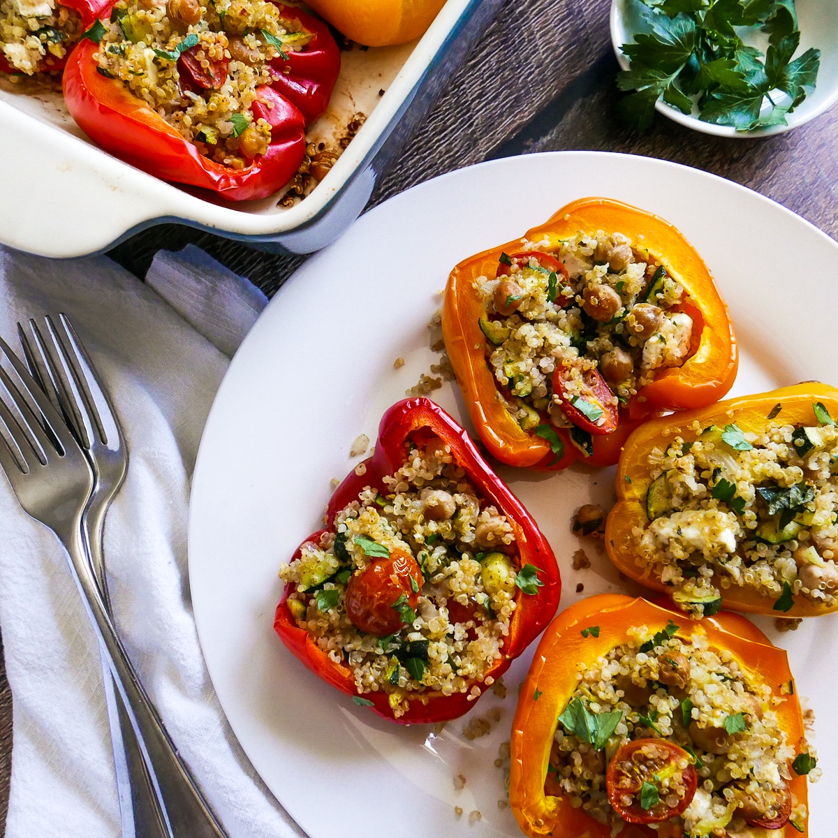 plate of vegetarian stuffed peppers with baking dish in the background. 