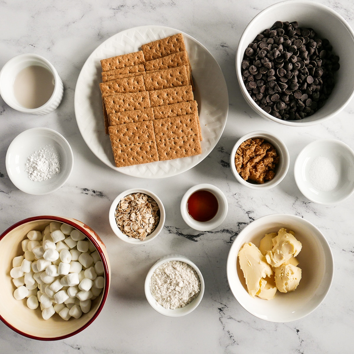 ingredients arranged in bowls and cups on a table.