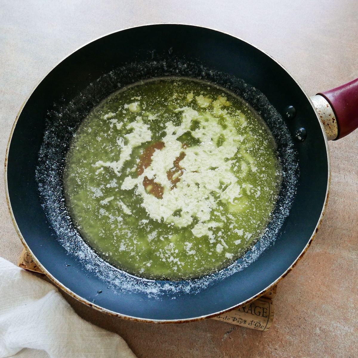 Making garlic butter in a small frying pan.