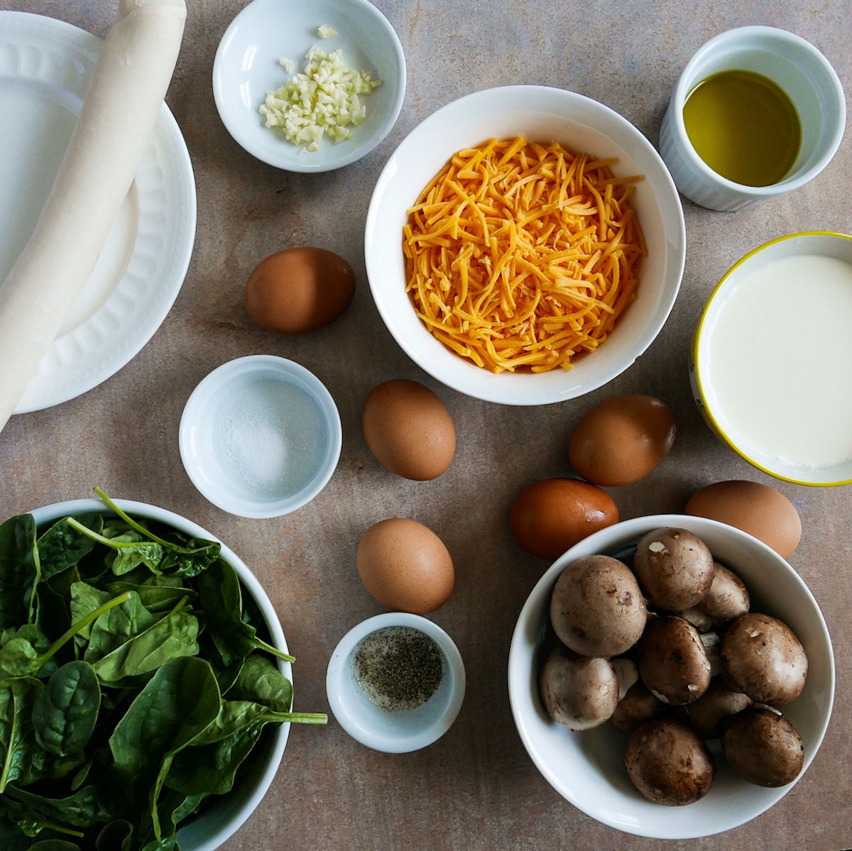 quiche ingredients arranged on a table.