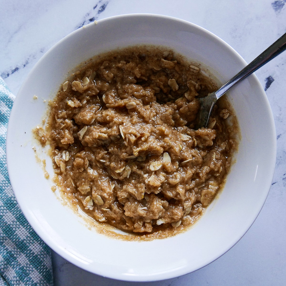 Biscuit batter combined in a small bowl with a spoon.