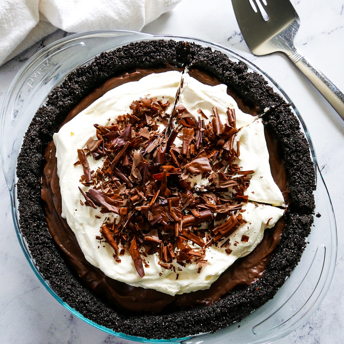 chocolate pie garnished with whipped cream and chocolate shavings. 